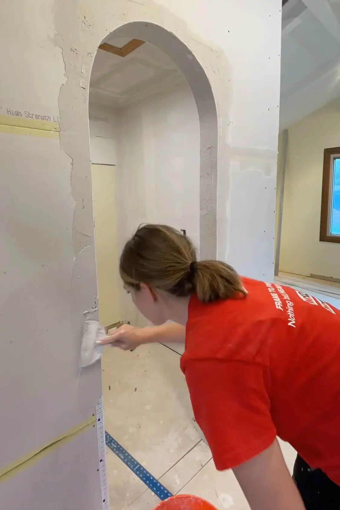 Adding mud to drywall. 
